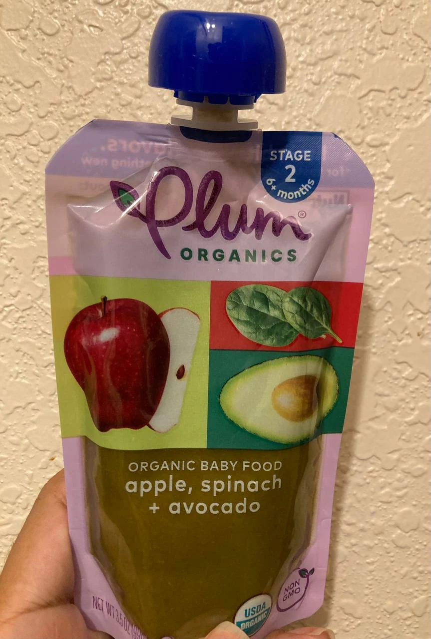 A pear, strawberry, and kale fruit pouch shown next to its ingredient list